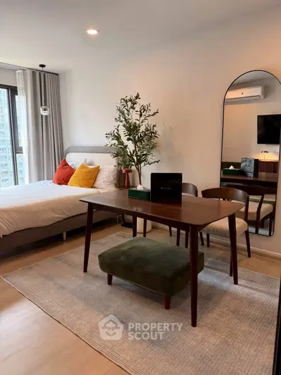 Chic modern bedroom with stylish furniture and large window view.