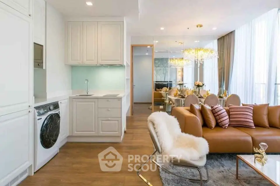 Luxurious open-plan living room with elegant decor and modern kitchen appliances