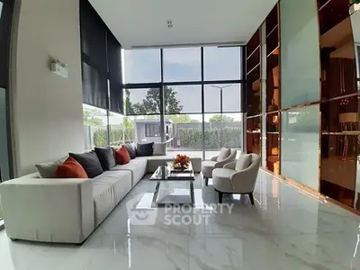 Luxurious modern living room with floor-to-ceiling windows and elegant furniture