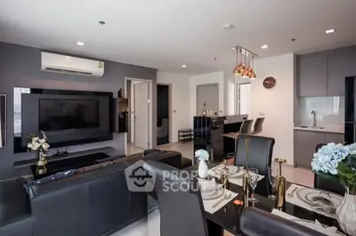 Modern open-plan living room with sleek kitchen and stylish dining area, perfect for contemporary living.
