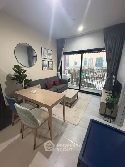 Modern living room with city view, stylish decor, and cozy seating area.