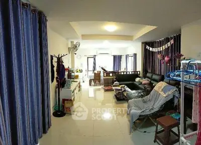 Spacious living room with modern decor and ample natural light