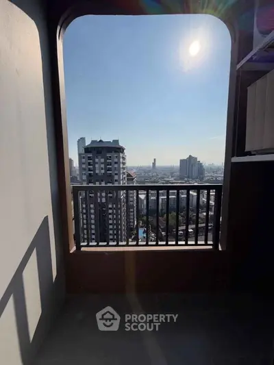 Stunning high-rise balcony view with cityscape and bright sunlight, perfect for urban living.
