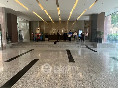 Elegant entrance of Sathorn Nakorn Tower with modern design and spacious lobby area.