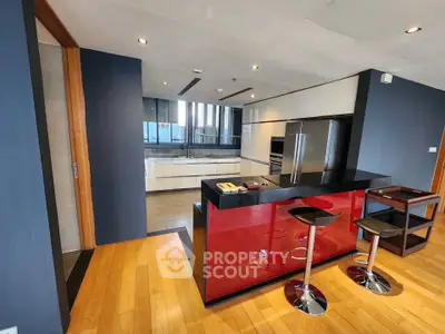 Modern kitchen with sleek red island and stainless steel appliances