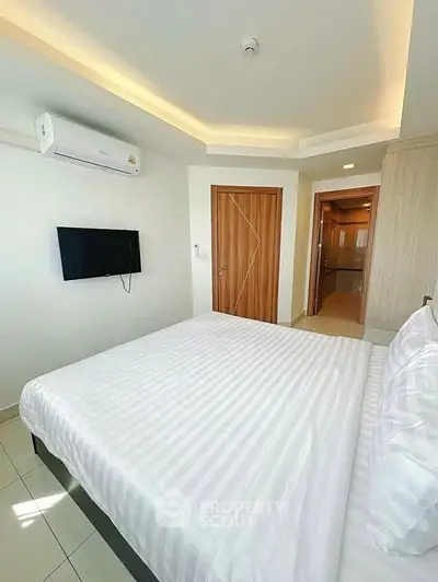 Modern bedroom with sleek design, featuring a wall-mounted TV and air conditioning for ultimate comfort.