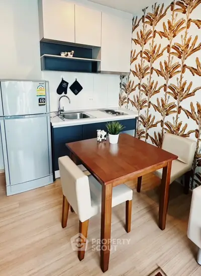 Modern compact kitchen with dining area and stylish wallpaper