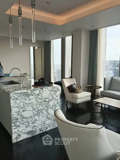 Luxurious modern living room with marble island and panoramic city views.