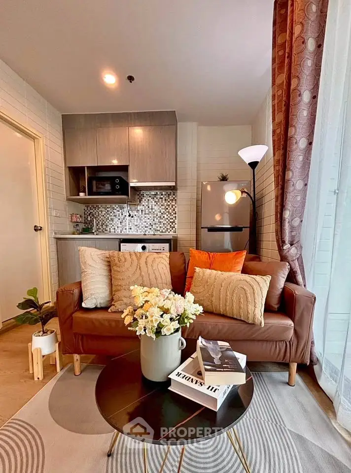 Chic modern living room with cozy sofa and stylish kitchen in open layout