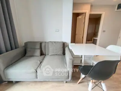 Modern living room with cozy sofa and dining table in stylish apartment