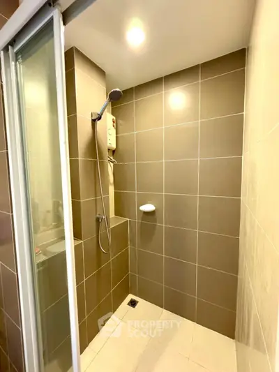 Modern bathroom with sleek brown tiles and shower area