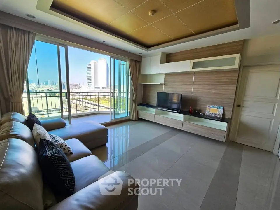 Spacious living room with city view and modern decor in high-rise apartment