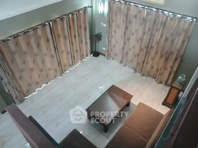 Spacious living room with elegant curtains and cozy seating area