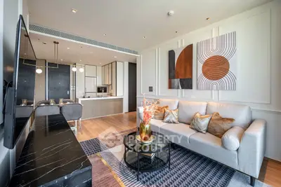 Luxurious modern living room with open kitchen, stylish decor, and elegant furniture