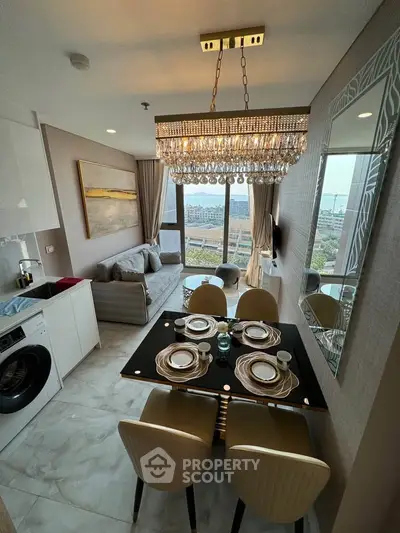 Luxurious dining and living area with elegant chandelier and city view