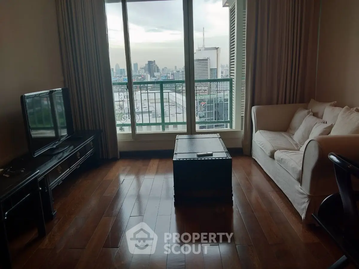 Cozy living room with city view, hardwood floors, and elegant furnishings.