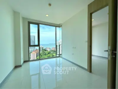 Spacious corner unit with stunning ocean view and large windows in modern apartment.
