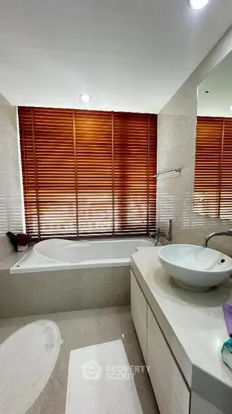 Luxurious bathroom with modern fixtures and elegant wooden blinds