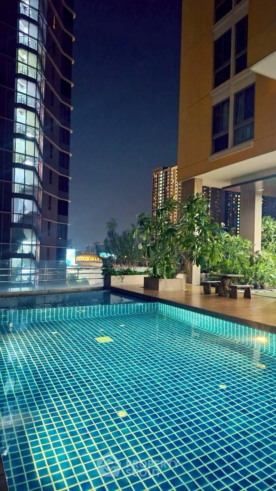 Luxurious rooftop pool with stunning city views at night