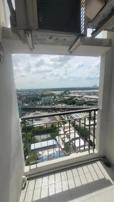 Stunning balcony view overlooking cityscape with expansive skyline and lush greenery.