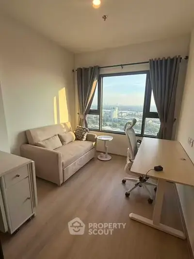 Cozy study room with a stunning city view, featuring a comfortable sofa and modern desk setup.
