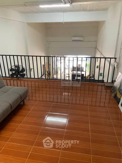 Spacious loft area with modern design and sleek tiled flooring, perfect for versatile living or office space.