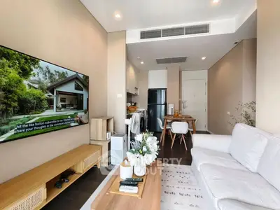 Modern living room with sleek furniture and wall-mounted TV in stylish apartment.