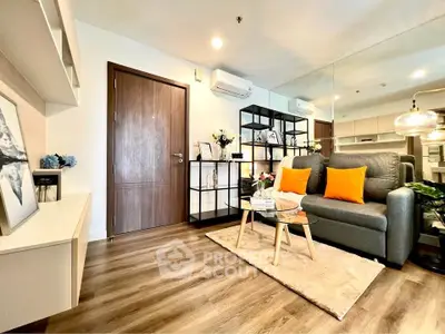 Modern living room with stylish decor, wooden flooring, and cozy seating area in a contemporary apartment.