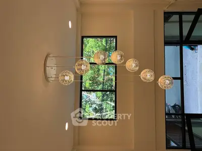 Modern interior with stylish pendant lighting and large window view