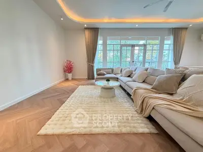 Spacious living room with elegant decor and large windows for natural light.