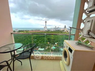 Stunning balcony view with seating and washing machine overlooking city skyline and ocean.