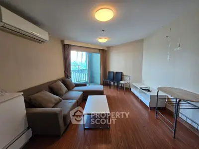 Spacious living room with modern furniture and balcony view in urban apartment