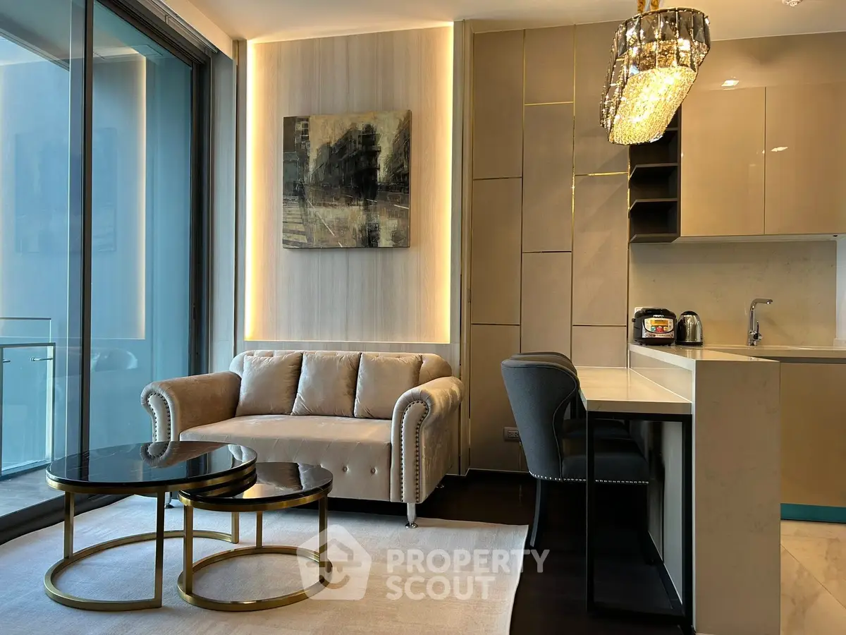 Luxurious modern living room with elegant sofa, stylish coffee tables, and chic kitchen area.