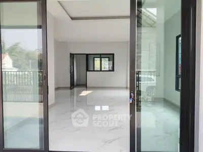 Spacious modern living room with large windows and marble flooring