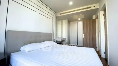 Modern bedroom with sleek design and ample natural light, featuring a comfortable bed and stylish decor.