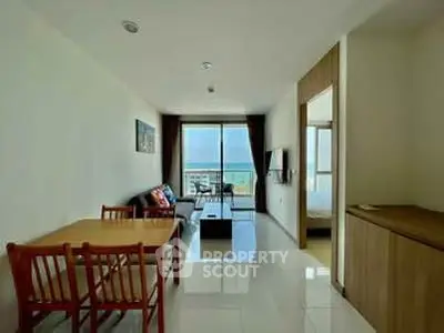 Spacious living room with ocean view and modern furnishings in a stylish apartment.