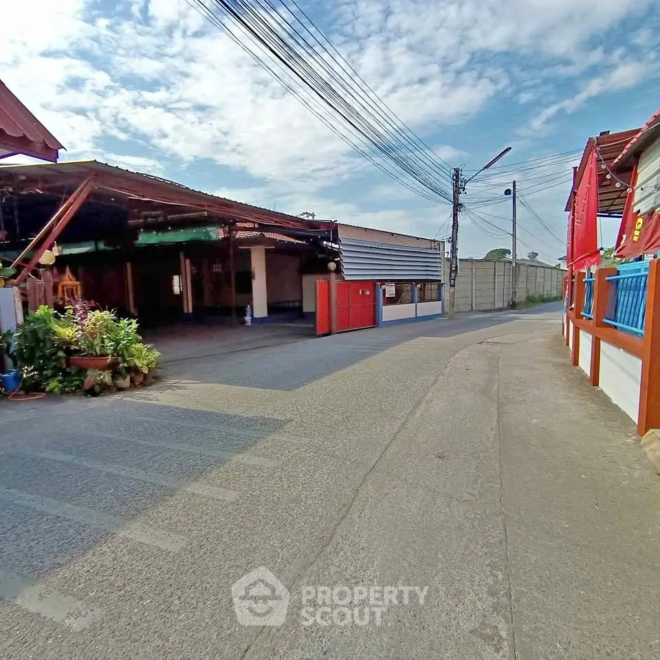 Charming street view with vibrant buildings and clear blue sky, ideal for real estate exploration.