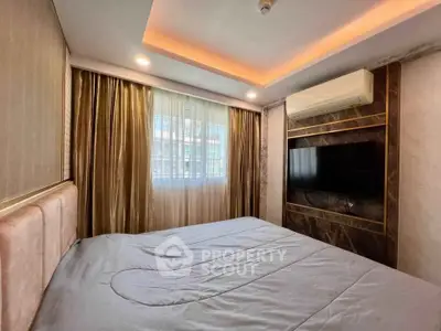 Luxurious bedroom with modern design, featuring ambient lighting and a wall-mounted TV for ultimate comfort.
