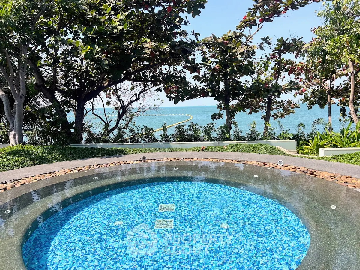 Luxurious outdoor pool with stunning ocean view surrounded by lush greenery, perfect for relaxation.