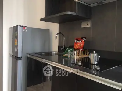 Modern kitchen with sleek black countertops and stainless steel appliances