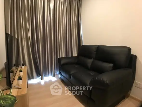 Cozy living room with black leather sofa and modern decor