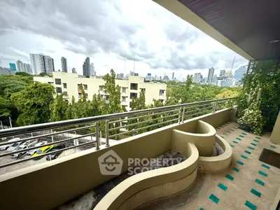 Spacious balcony with city skyline view, perfect for relaxation and enjoying urban living.