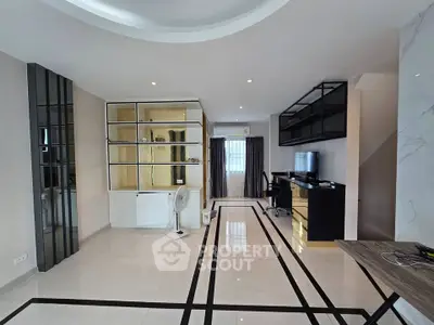 Spacious modern living room with sleek design and built-in shelving, perfect for contemporary living.