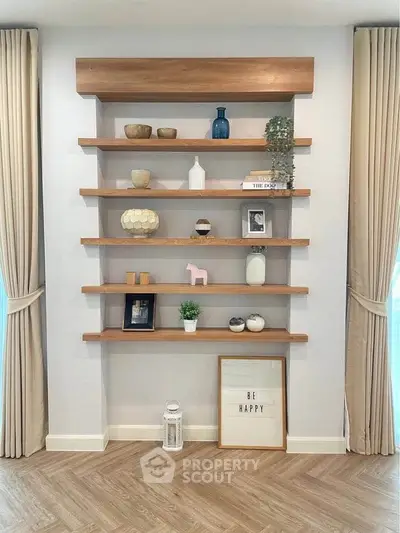 Stylish living room with elegant wooden shelves and decorative items.