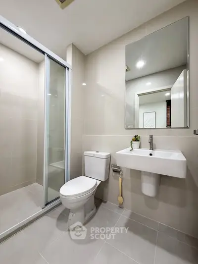 Modern bathroom with sleek fixtures and glass shower enclosure
