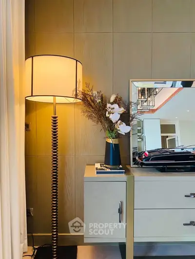 Stylish modern living room corner with elegant lamp and decorative mirror