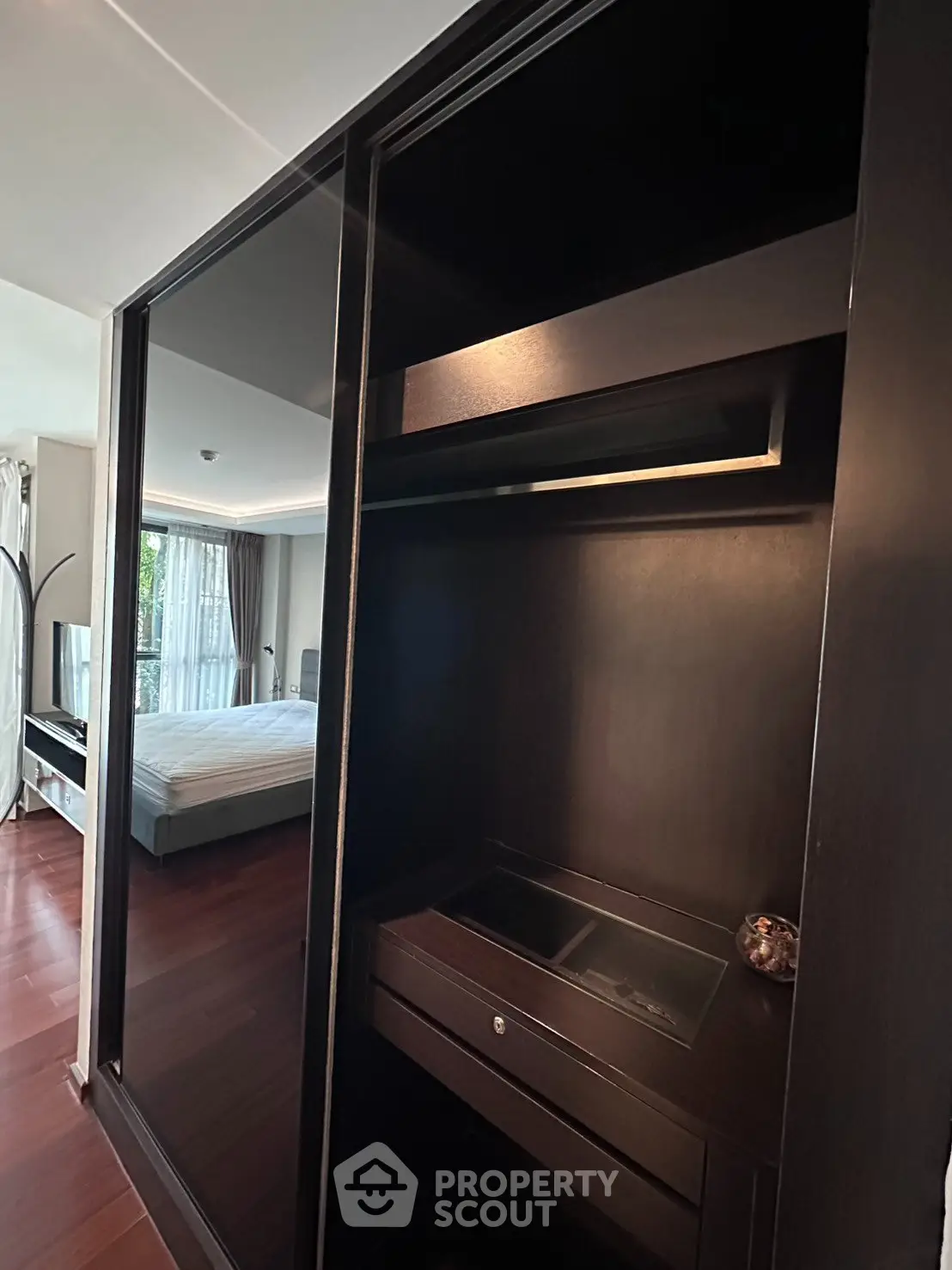 Modern bedroom with sleek built-in wardrobe and large window view
