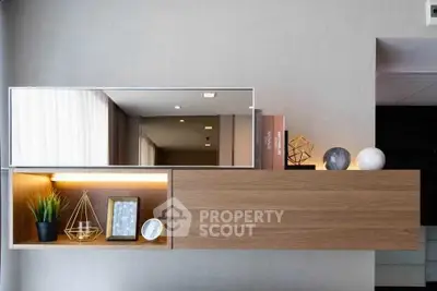 Modern interior shelf with decorative items and mirror in stylish living room.