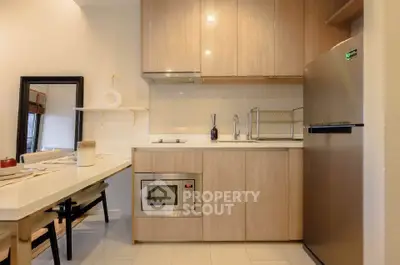 Modern kitchen with sleek wooden cabinets and stainless steel appliances