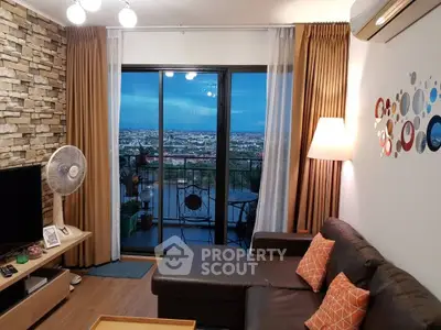 Stylish living room with balcony view, modern decor, and cozy seating area.